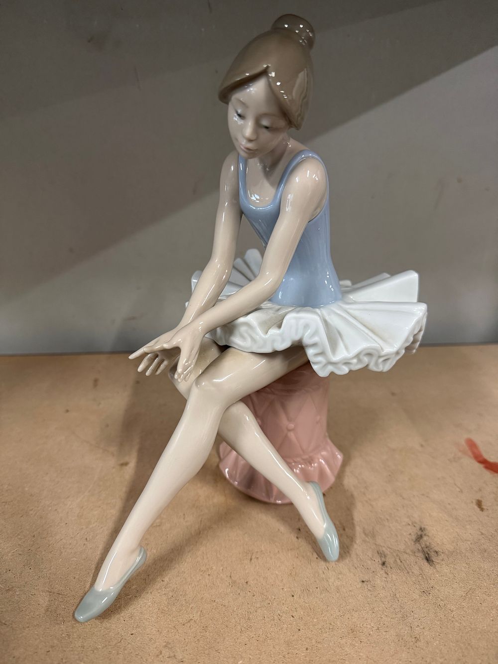 Lot 65: A NAO by Lladro porcelain figurine of a seated ballerina