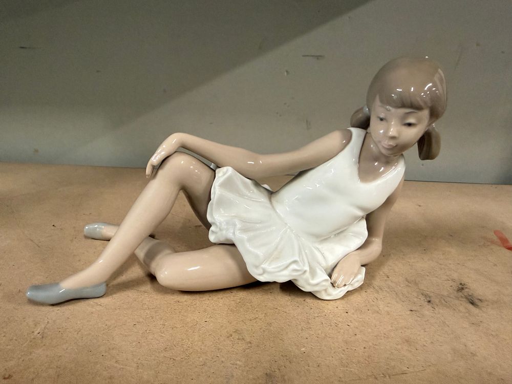 Lot 66: A Nao porcelain figurine of a reclining young ballerina