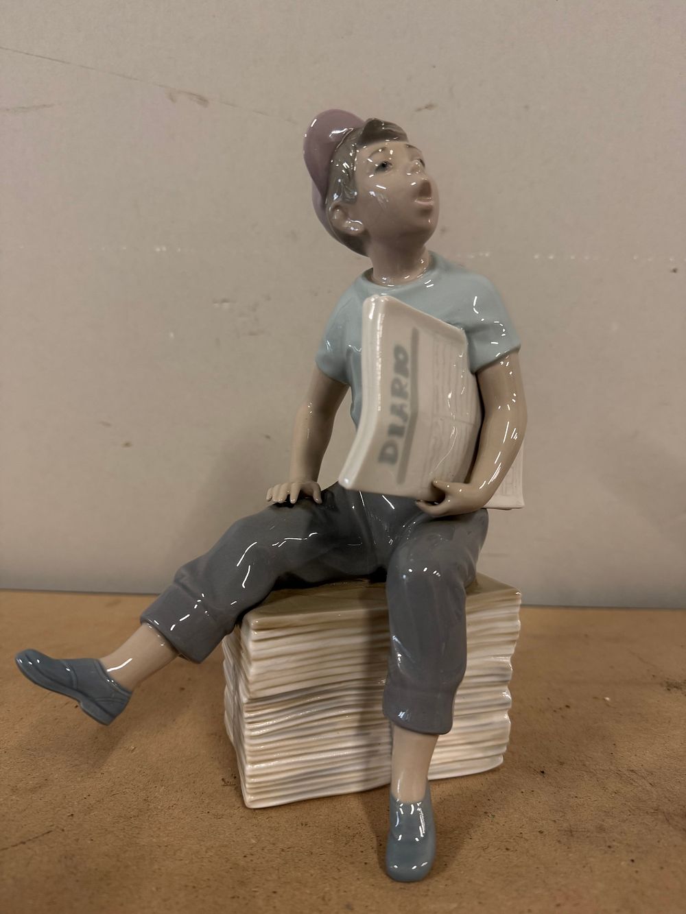 Lot 67: A Spanish Nao by Lladró porcelain figure of a paperboy