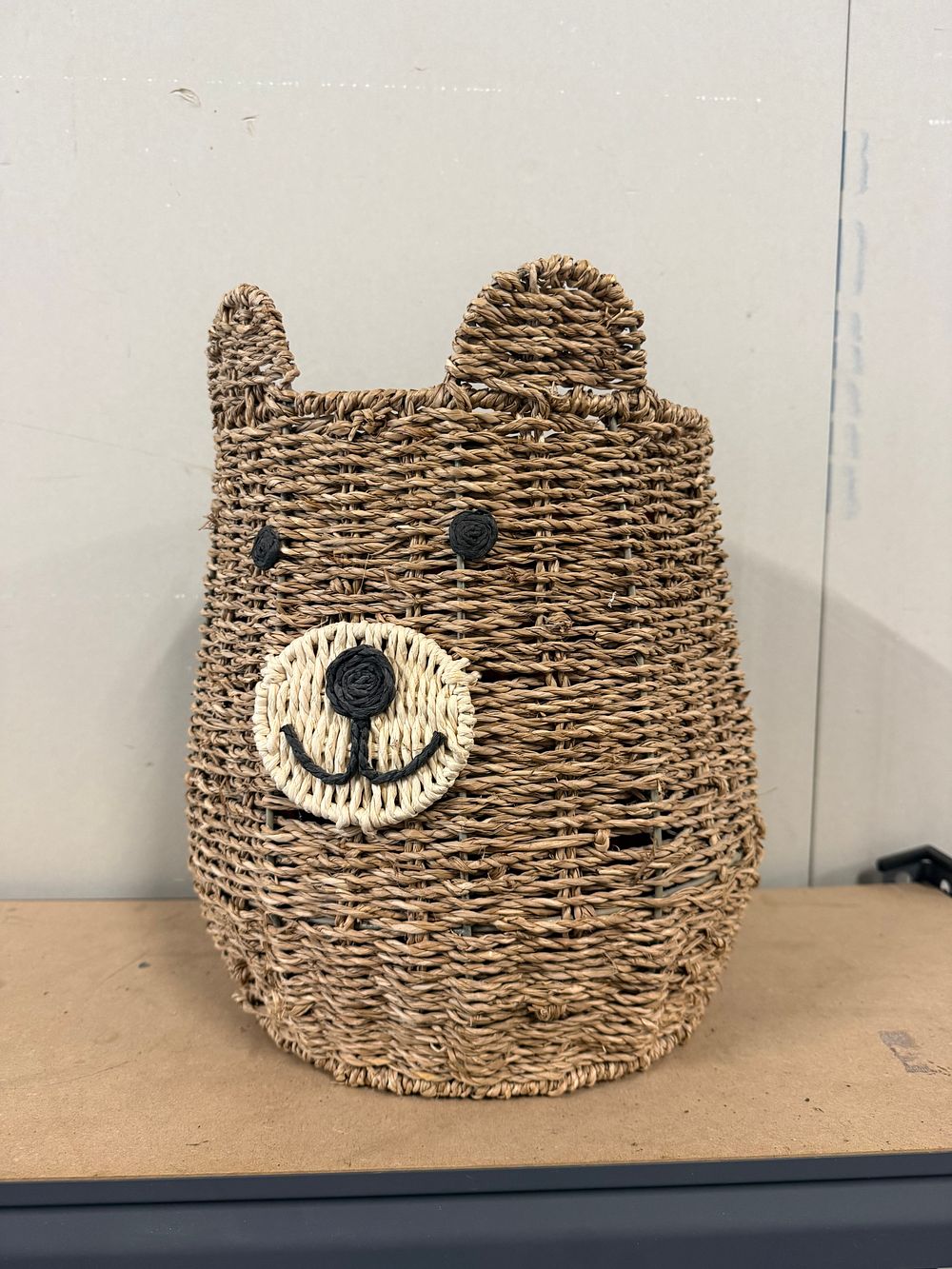 Lot 68: A novelty woven seagrass bear storage basket with red lining