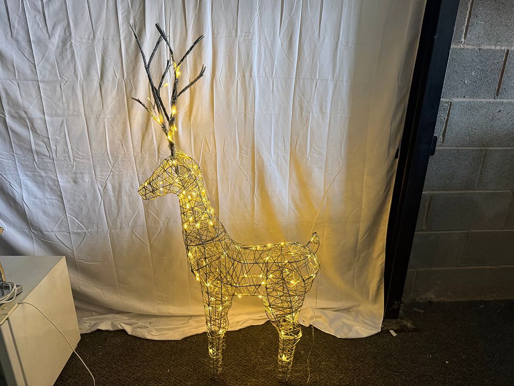 Lot 70: An illuminated wirework reindeer holiday sculpture