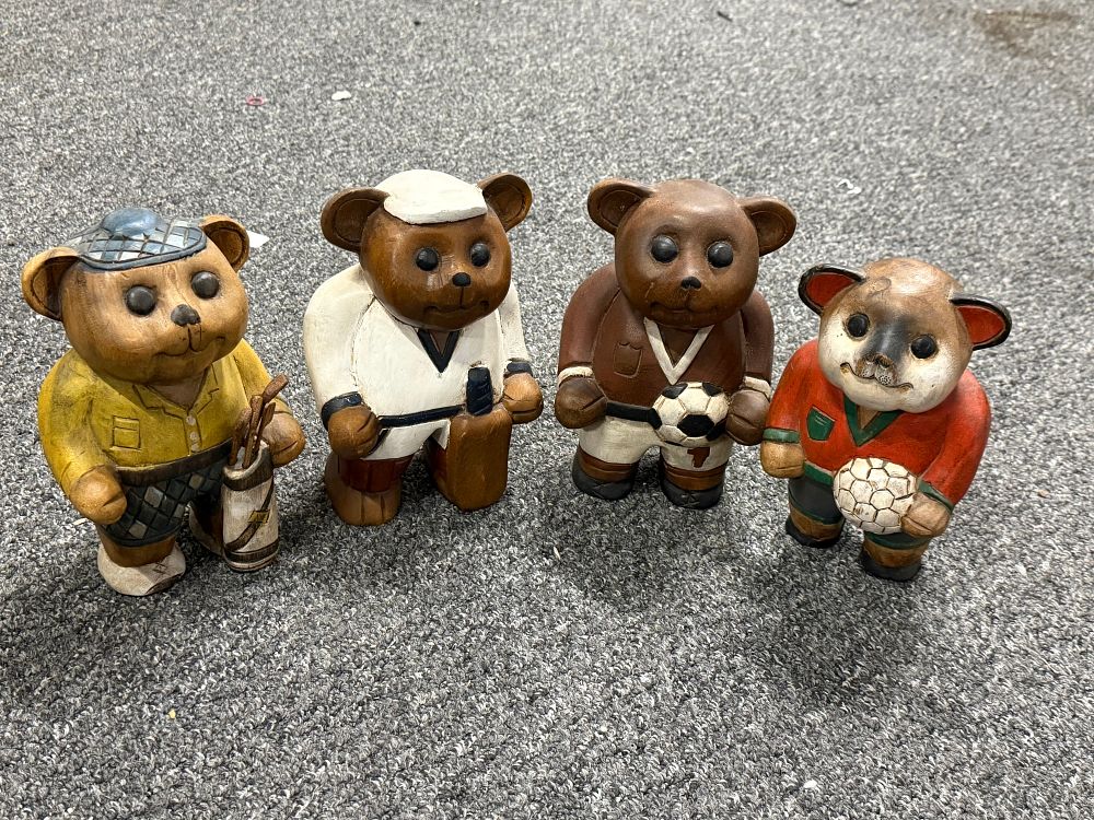Lot 75: A collection of four hand painted carved wooden sports bears