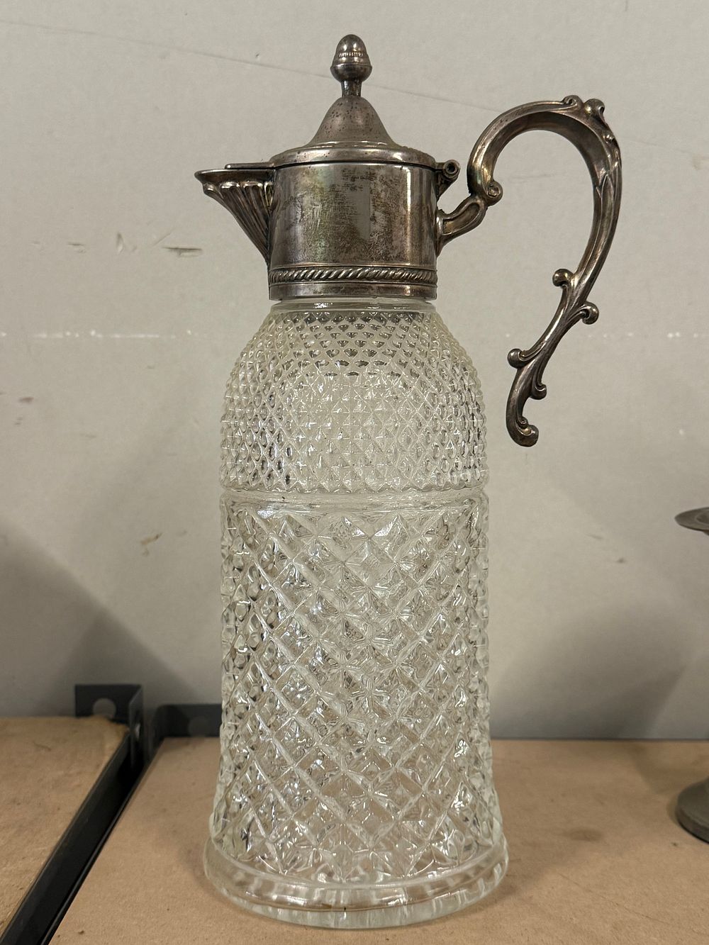 Lot 85: A Victorian style silver plated and diamond cut glass claret jug