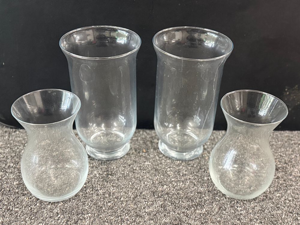 Lot 91: A group of clear glass hurricane and bud vases
