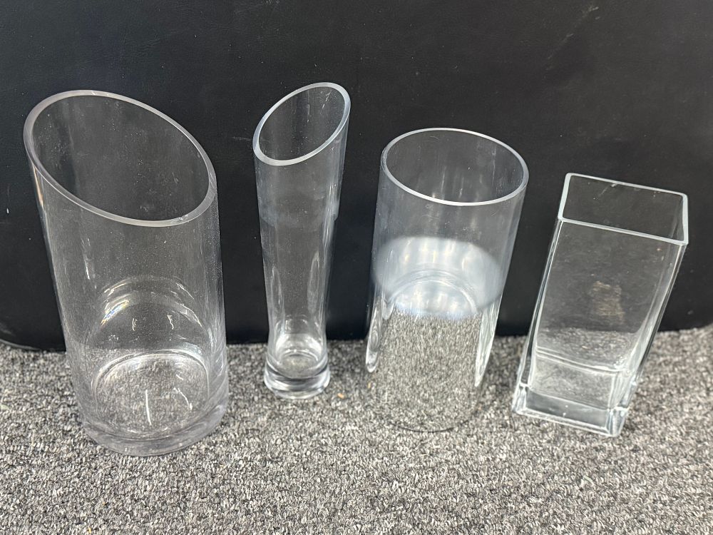 Lot 92: A group of four contemporary clear glass vases Tallest are 12 inches.