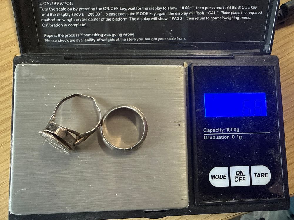 Lot 110: Two sterling silver rings including a decorative locket style ring