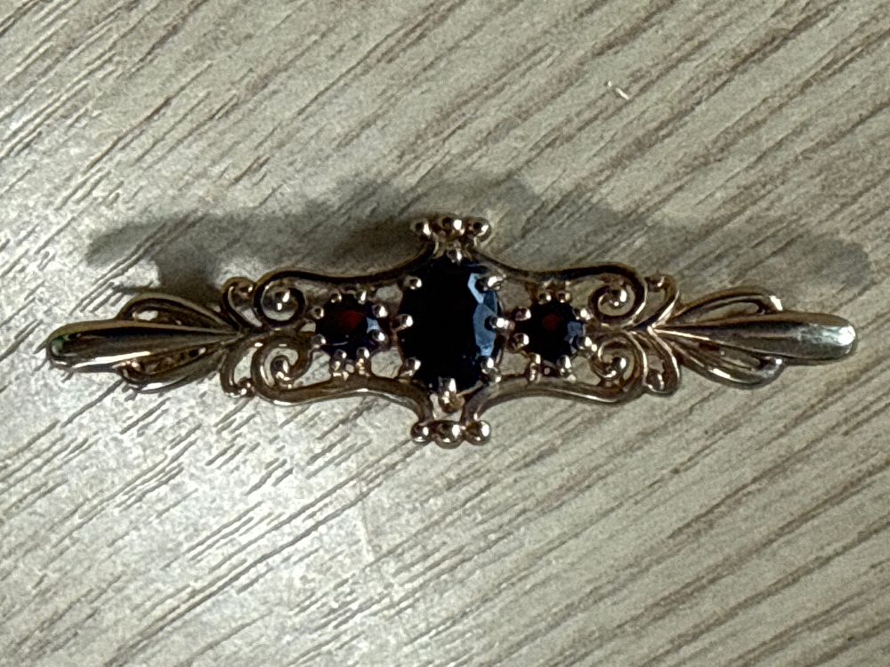 Lot 114: A Victorian 9 Carat Gold and ruby Bar Brooch 3 Grams