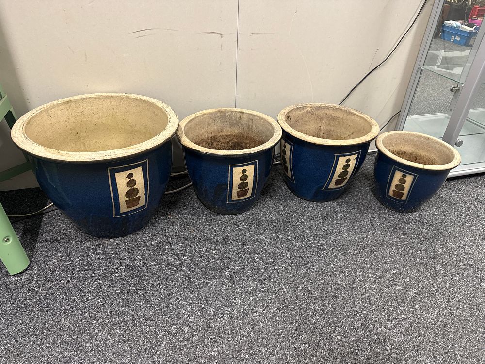 Lot 128: A set of four cobalt blue glazed ceramic garden planters