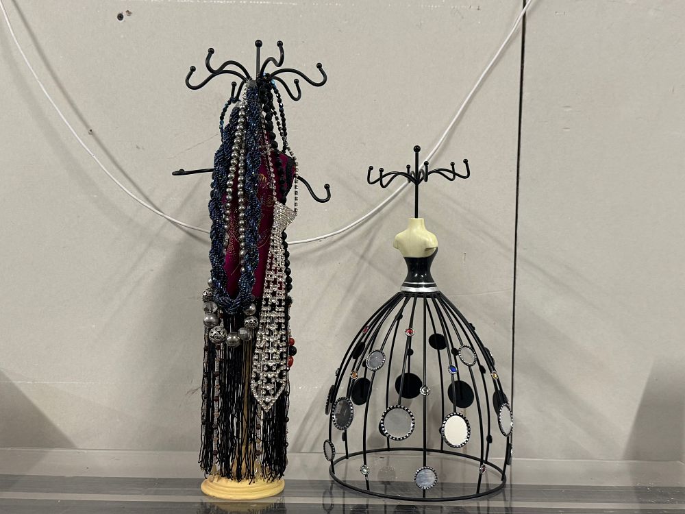 Lot 146: Two mannequin-style jewelry display stands with assorted costume jewelry