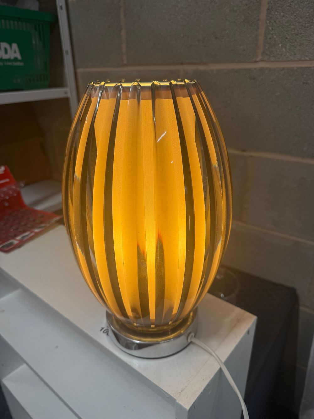 Lot 148: A contemporary surface mounted wall light with amber glass shade