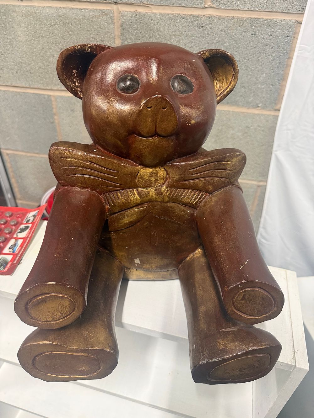 Lot 149: A hand carved and gilt painted wooden seated teddy bear