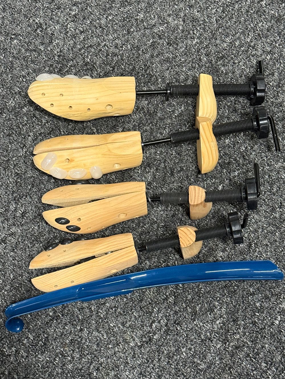 Lot 152: A set of four wooden shoe stretchers and shoe horn