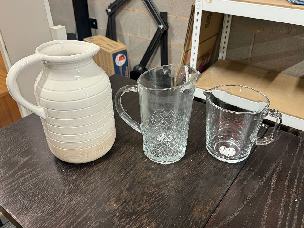 Lot 170: A trio of glass and ceramic kitchen pitchers