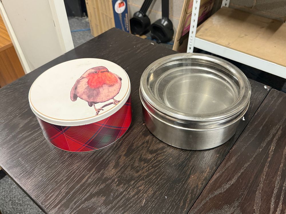 Lot 171: A collection of tartan wildlife storage tins and a stainless steel food carrier