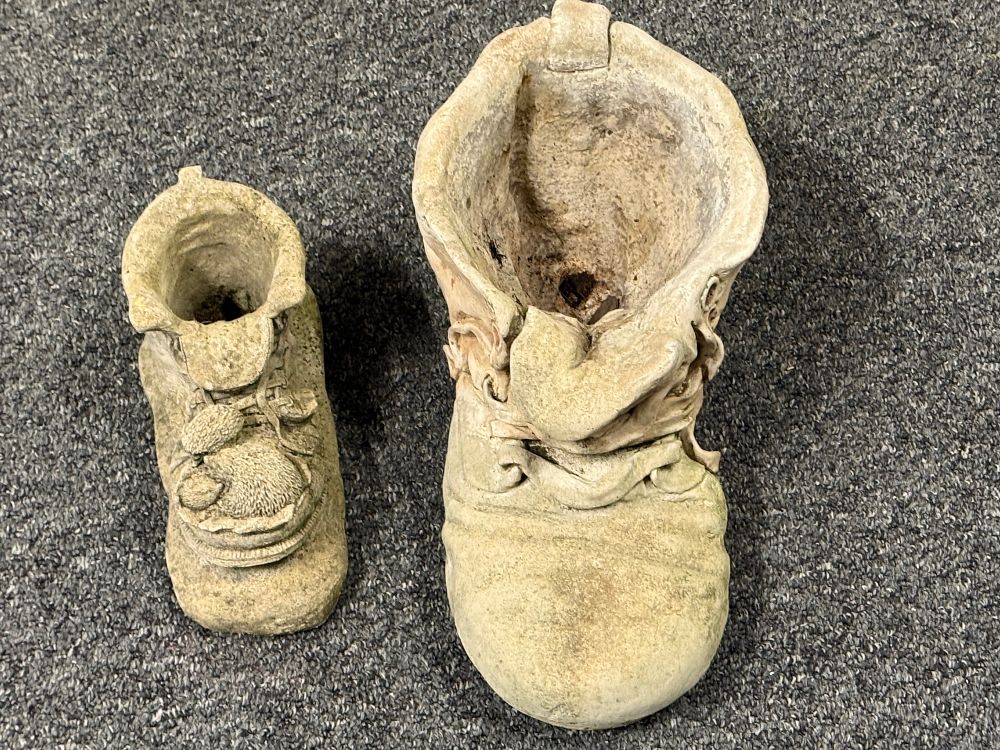 Lot 176: A weathered cast stone boot garden planters