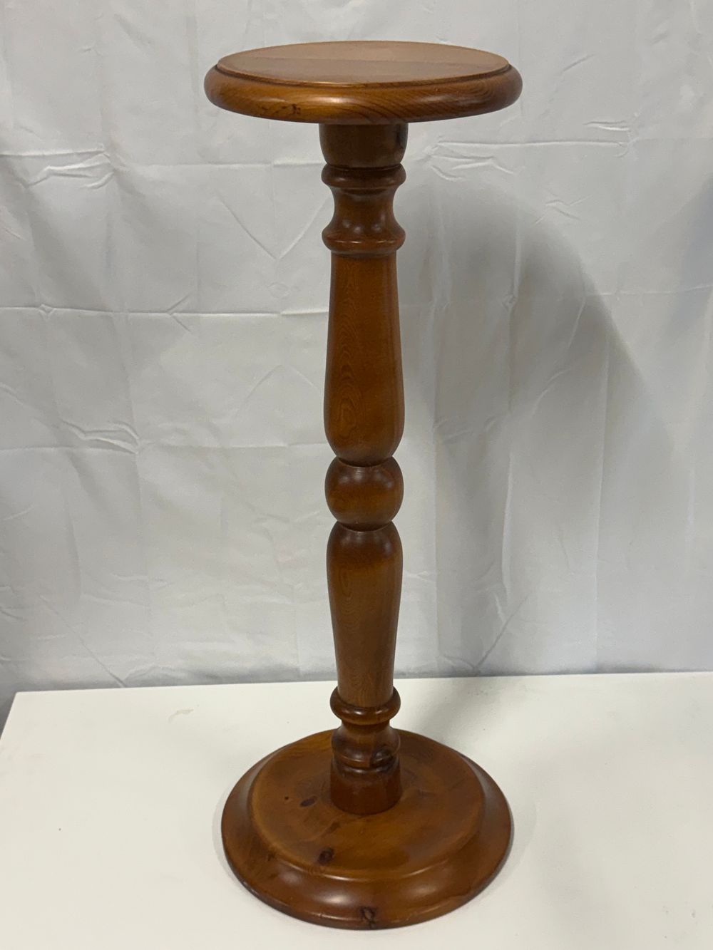Lot 185: A traditional turned pine plant stand with a medium oak finish