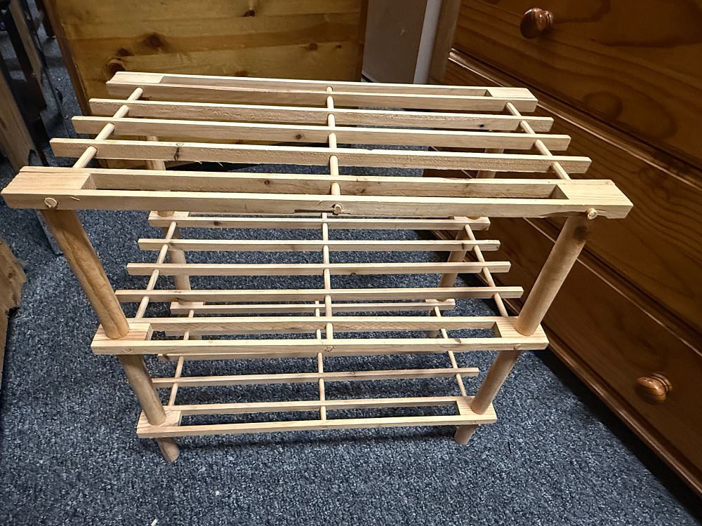 Lot 189: A three tier open slatted light wood shoe rack