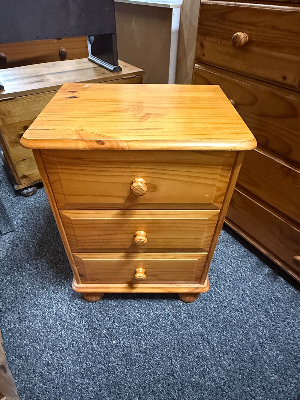 Lot 194: A contemporary solid pine three drawer bedside chest