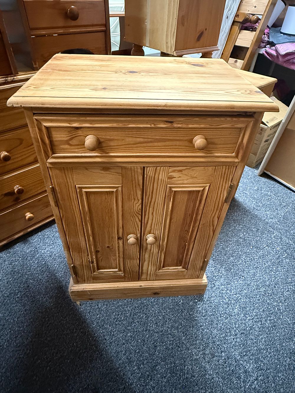 Lot 196: A modern solid pine bedside cupboard with drawer