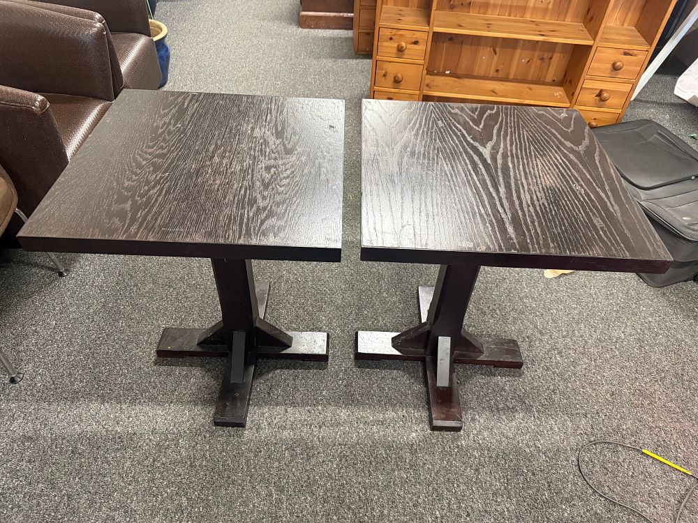 Lot 203: A pair of dark stained ash veneered bistro dining tables