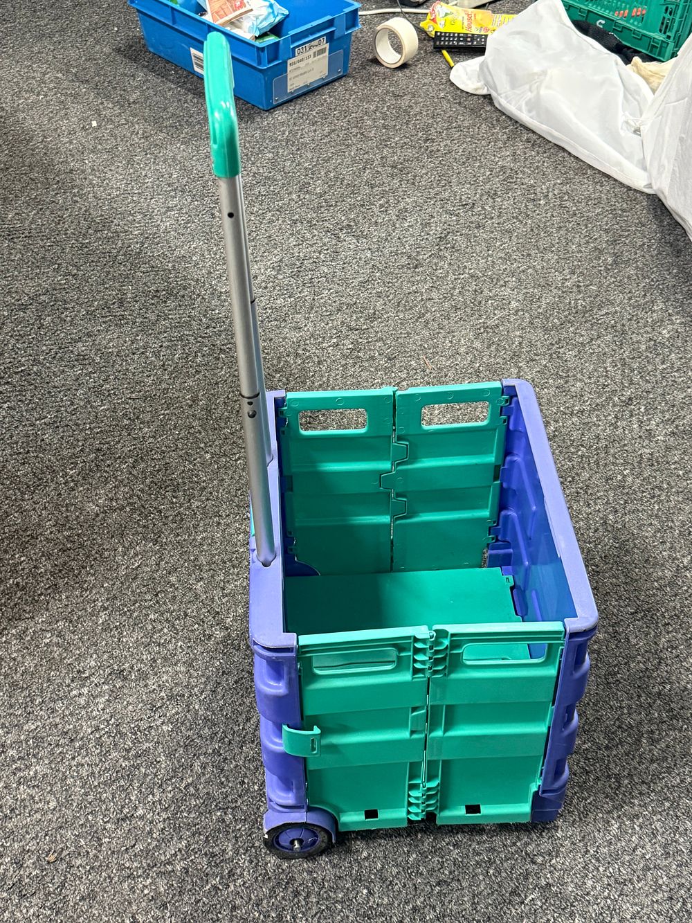 Lot 213: A folding plastic crate trolley in purple and teal