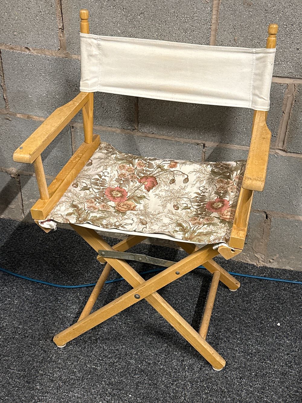 Lot 215: A vintage wooden folding director's chair with floral seat