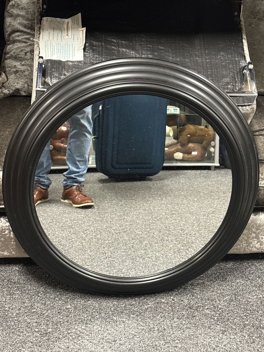 Lot 229: A contemporary round wall mirror in a black moulded frame