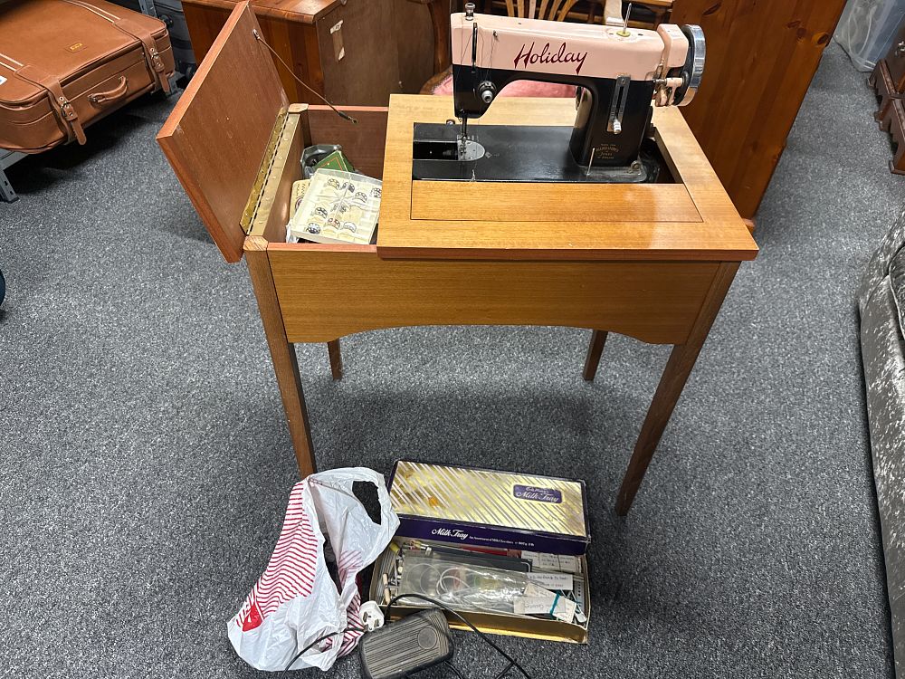 Lot 232: A mid-century Holiday electric sewing machine in a wooden cabinet