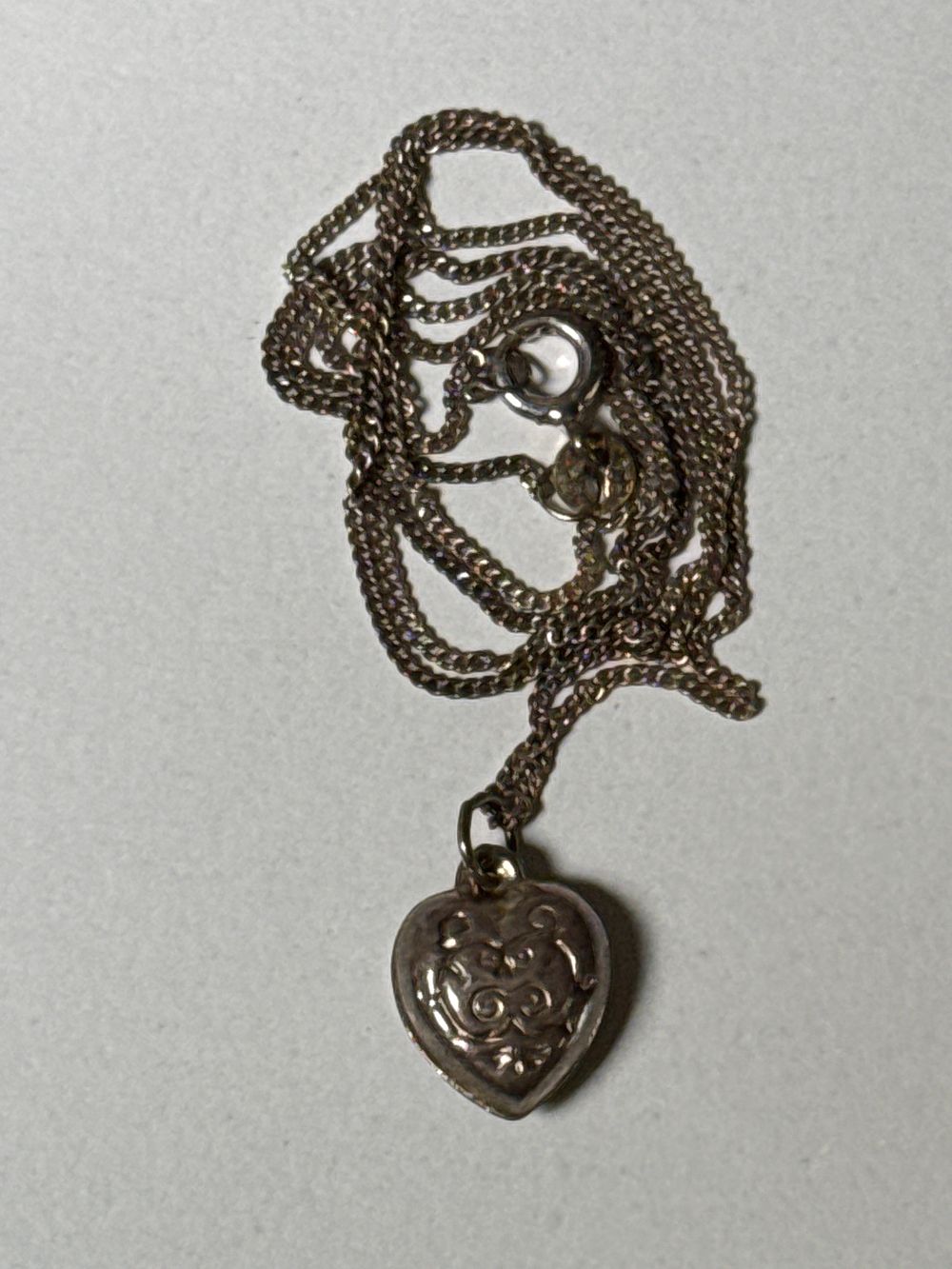 Lot 125c: A Sterling Silver heart shaped pendant on curb link chain