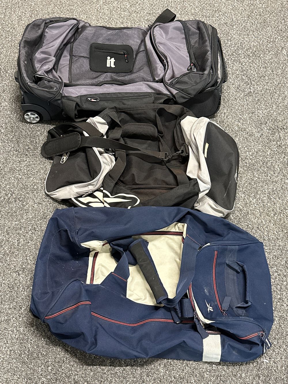 Lot 233a: 2 REEBOK AND A TRIP trio of large synthetic travel and sports duffle bags