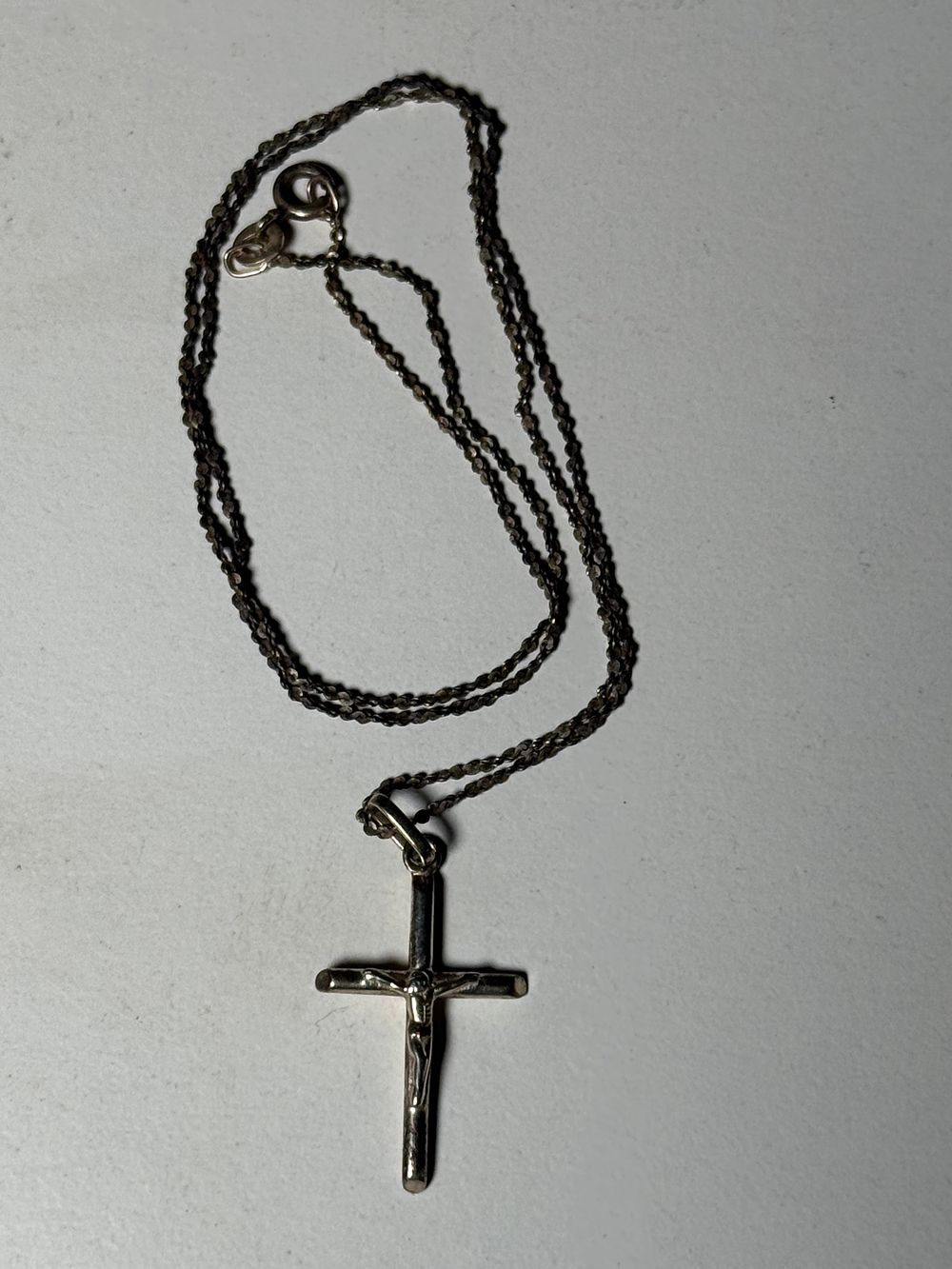 Lot 127d: A sterling silver crucifix pendant on a curb link necklace