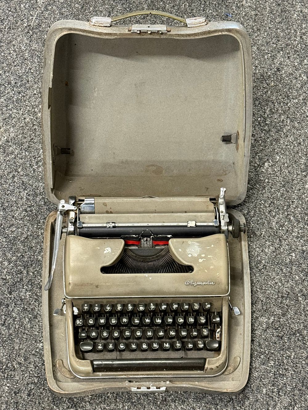 Lot 242: A vintage Olympia portable manual typewriter in original hard-shell case