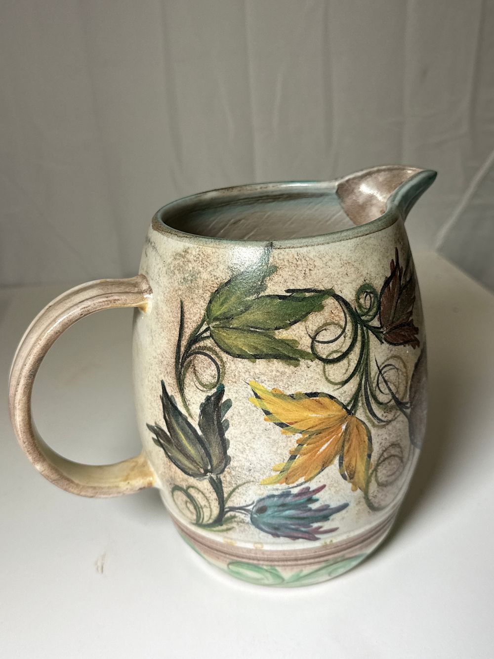 Lot 243: Signed Glyn Colledge English hand painted earthenware pitcher with botanical motifs
