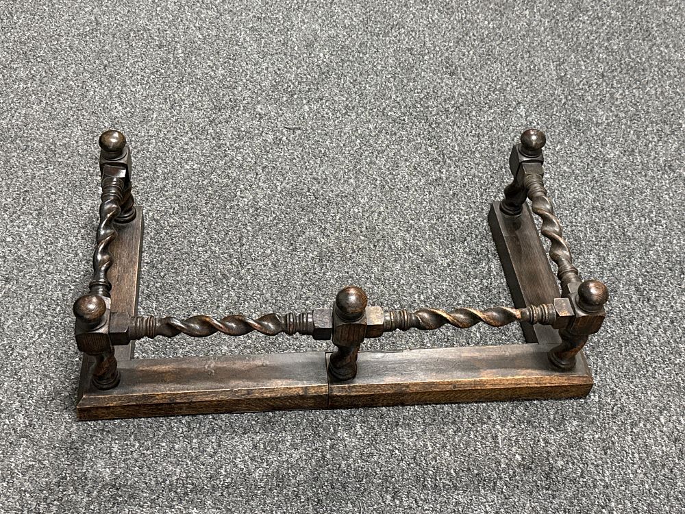 Lot 245: A dark stained oak barley twist fireplace fender