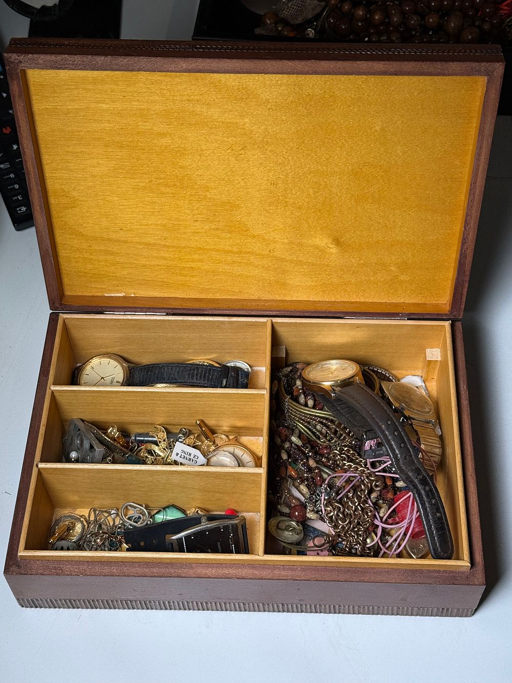 Lot 246: A vintage wooden jewellery box containing an assortment of watches and costume jewellery