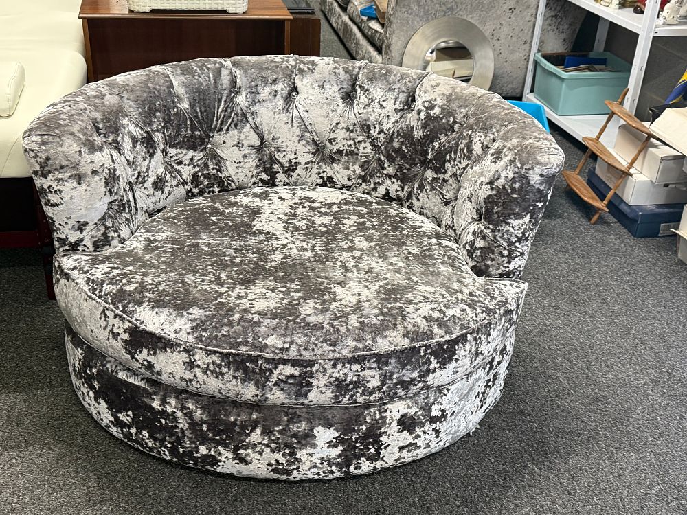 Lot 285: A silver crushed velvet swivel cuddle chair