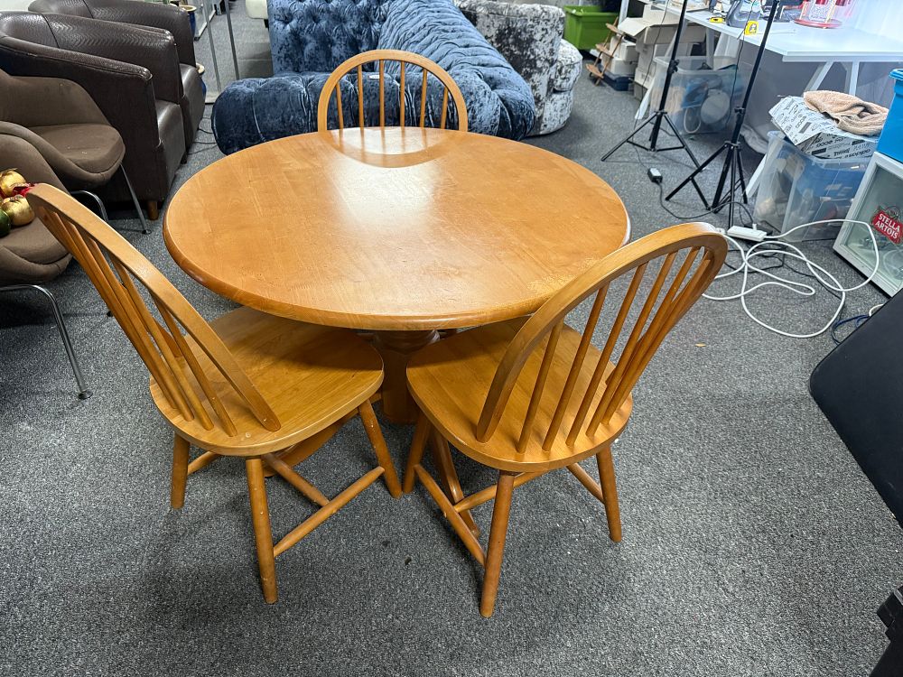 Lot 287: A circular pedestal dining table and three matching chairs