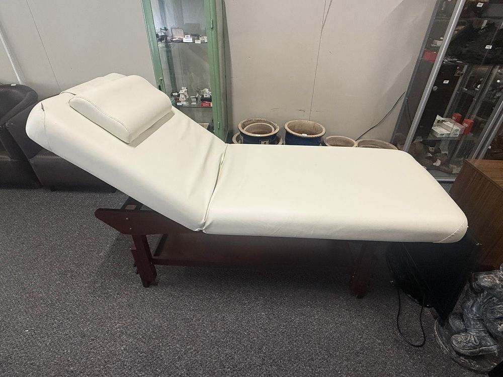 Lot 290: A professional two section stationary massage table with wooden base