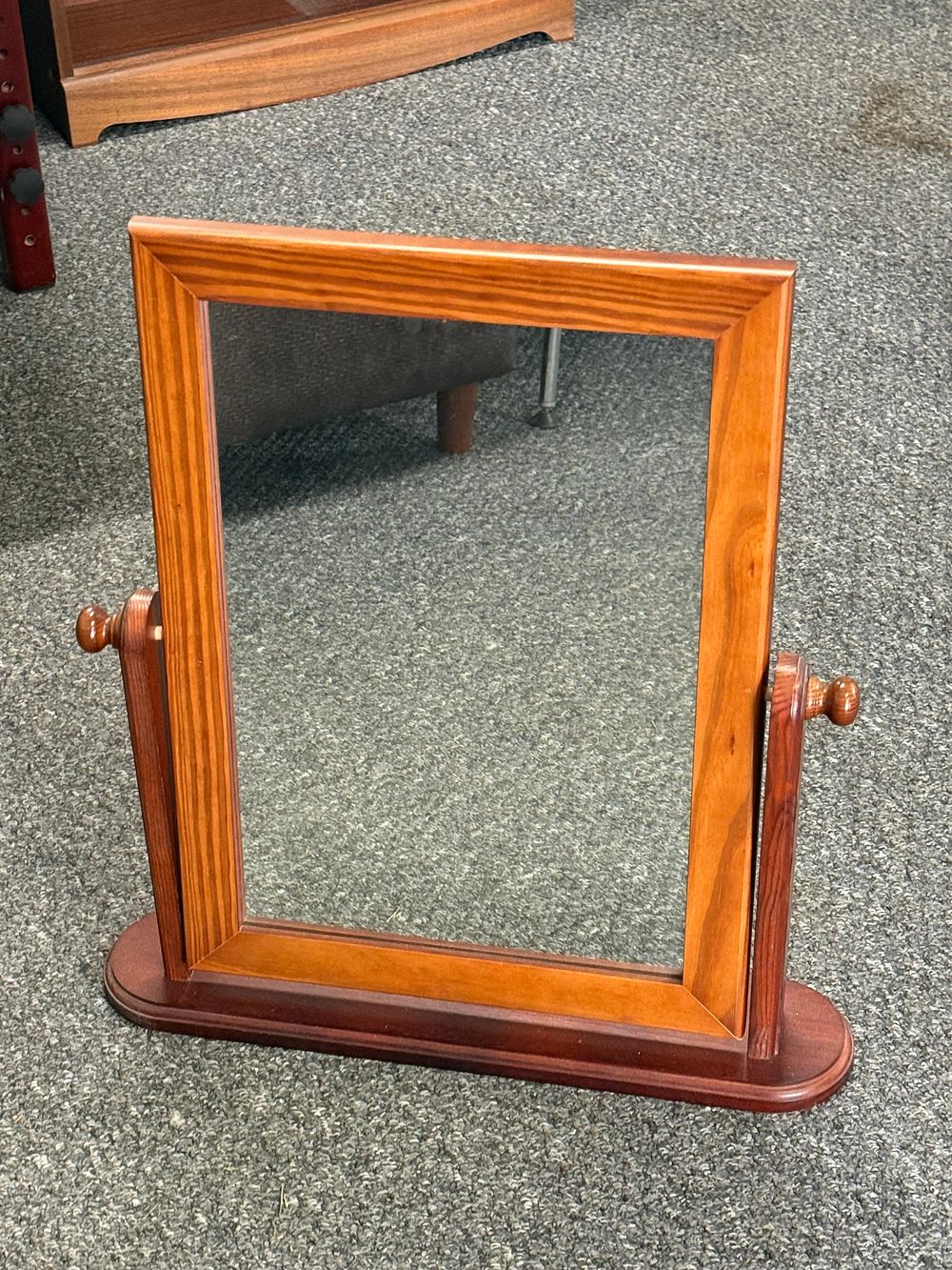 Lot 296: A wooden swing mirror with a tilting frame