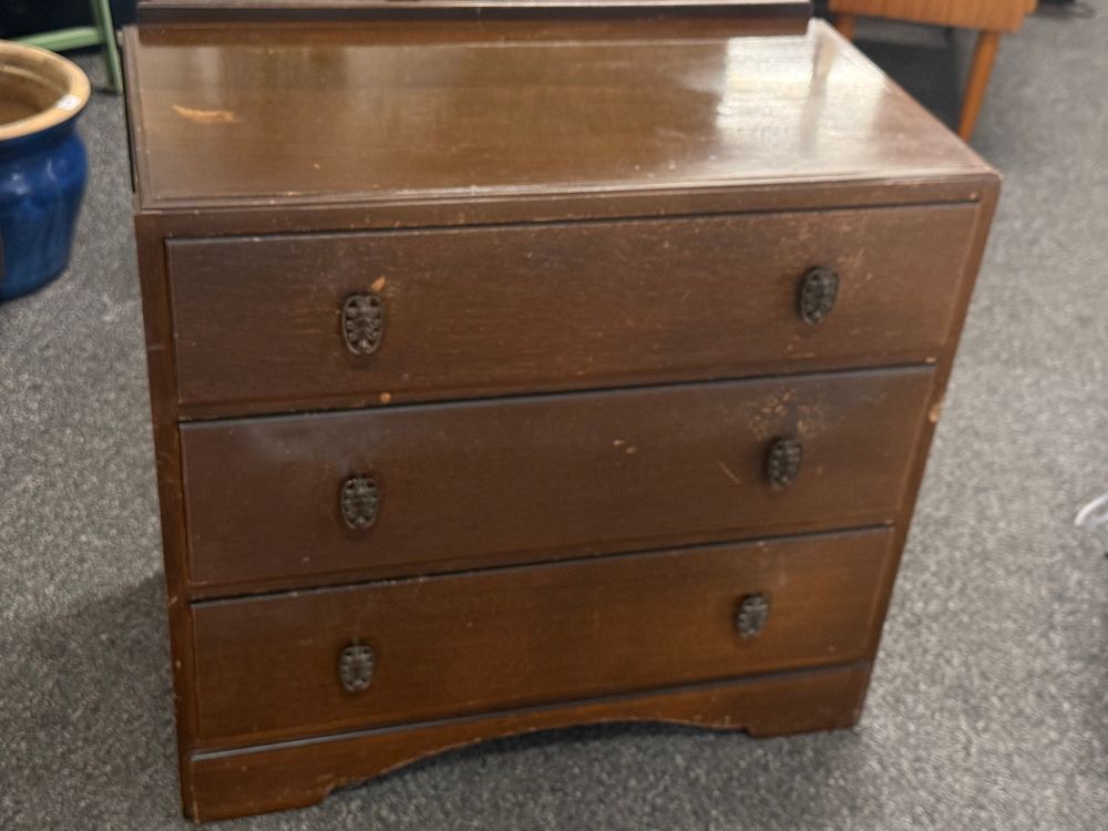 Lot 298: A mid-century stained wood three drawer chest of drawers