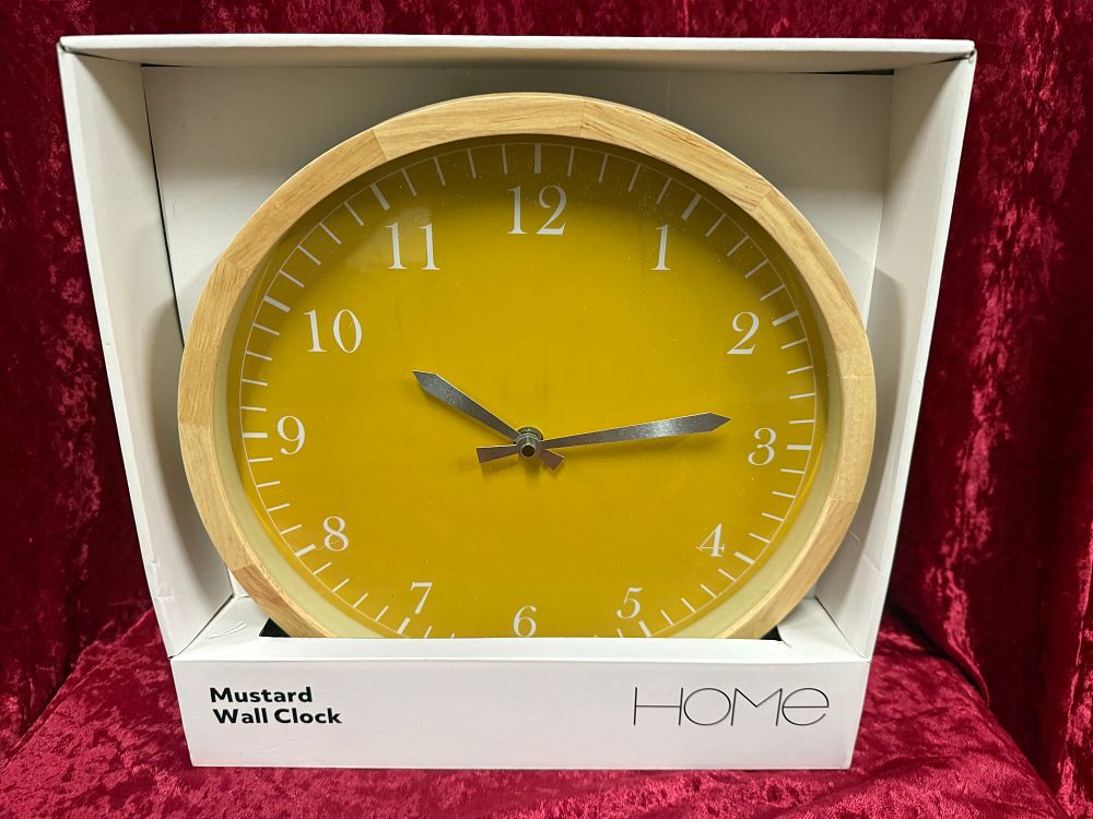 Lot 17: A circular mustard yellow HOME brand wooden wall clock