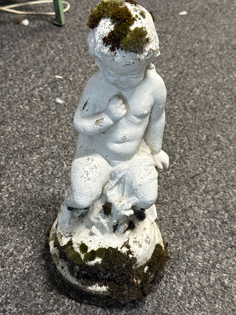 Lot 42: Weathered cast stone garden statue of a reclining cherub