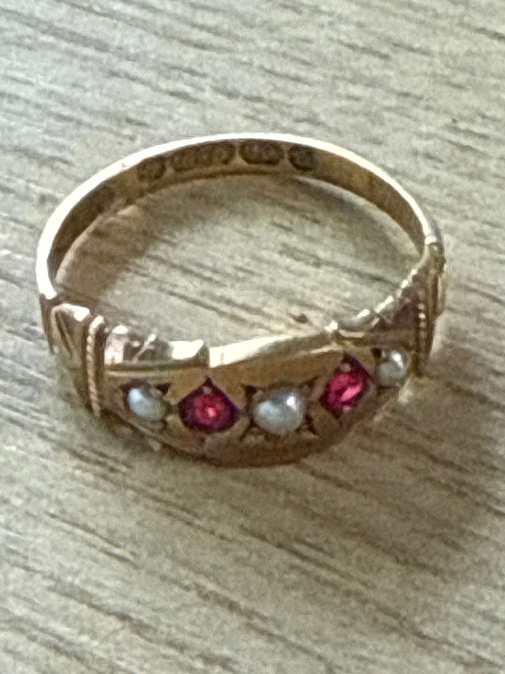Lot 48: A Victorian style 9 carat gold ruby and pearl bridge ring
