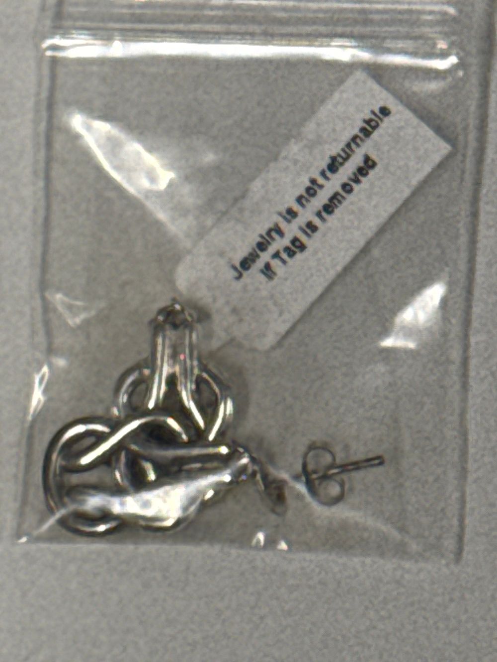 Lot 58: A pair of sterling silver openwork knot drop earrings