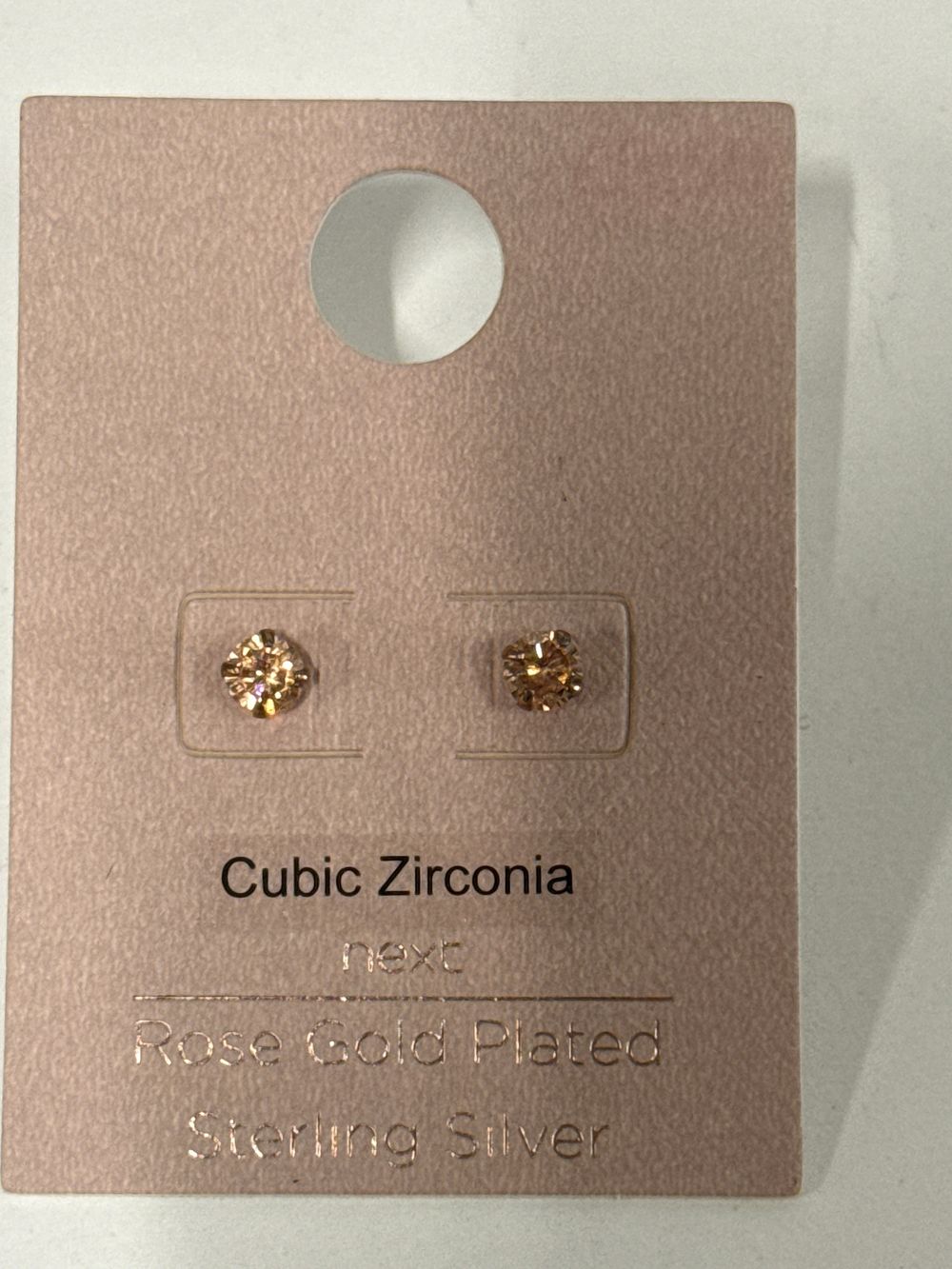 Lot 60: A pair of sterling silver and rose gold plated cubic zirconia stud earrings