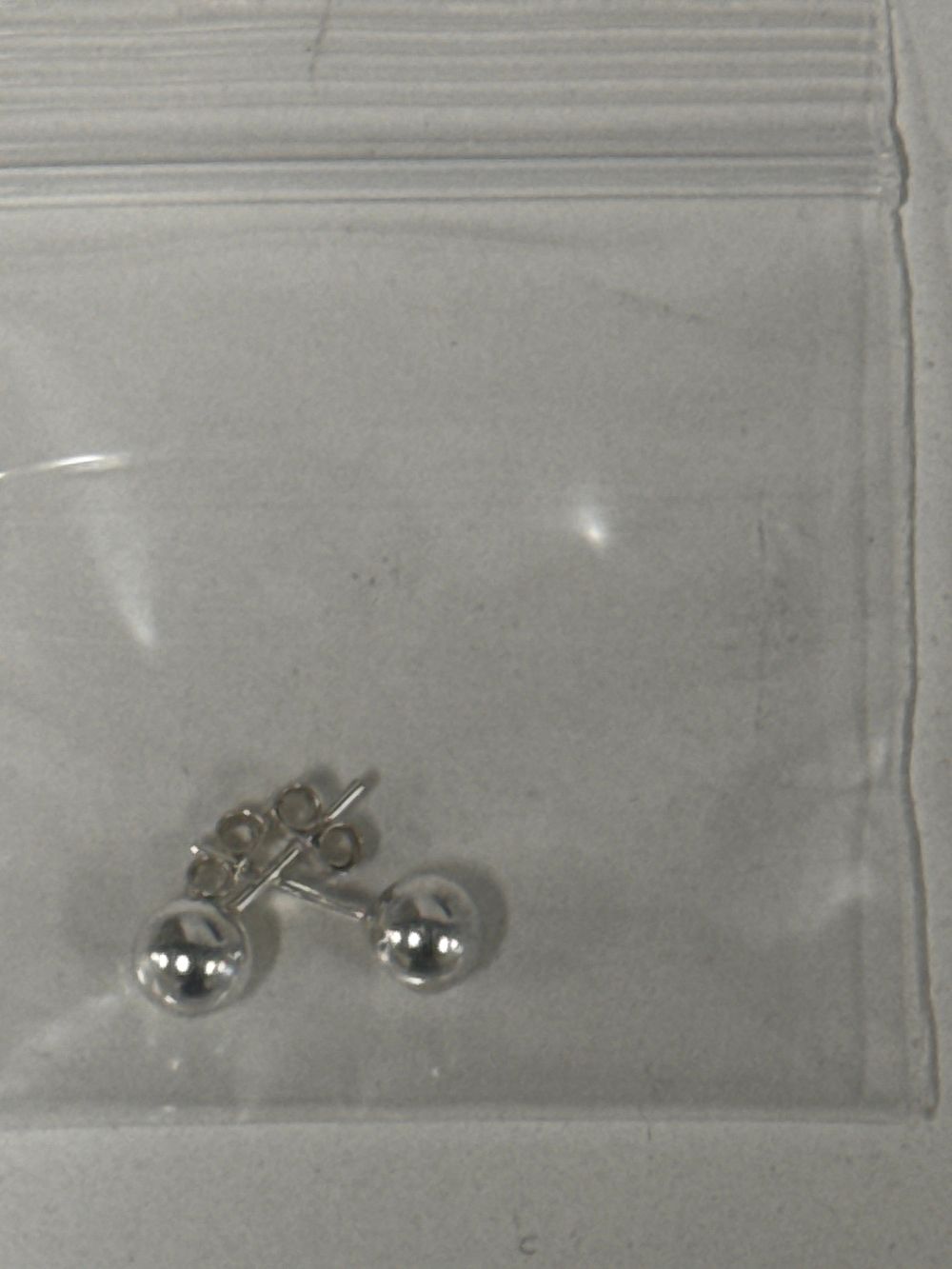 Lot 61: A Pair of Sterling Silver Ball Stud Earrings