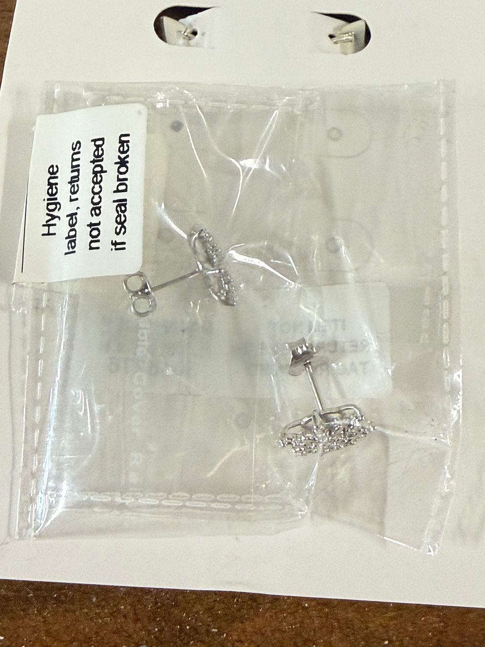 Lot 75: A pair of white metal flower cluster stud earrings