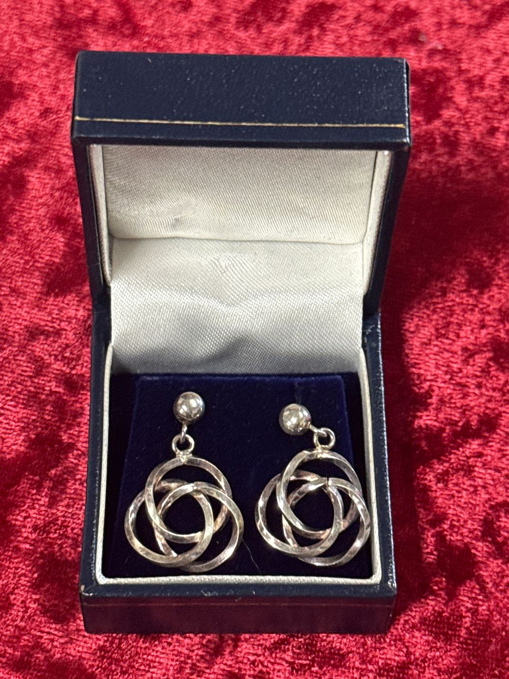 Lot 77: A Pair of Silver Interlocking Triple Ring Drop Earrings