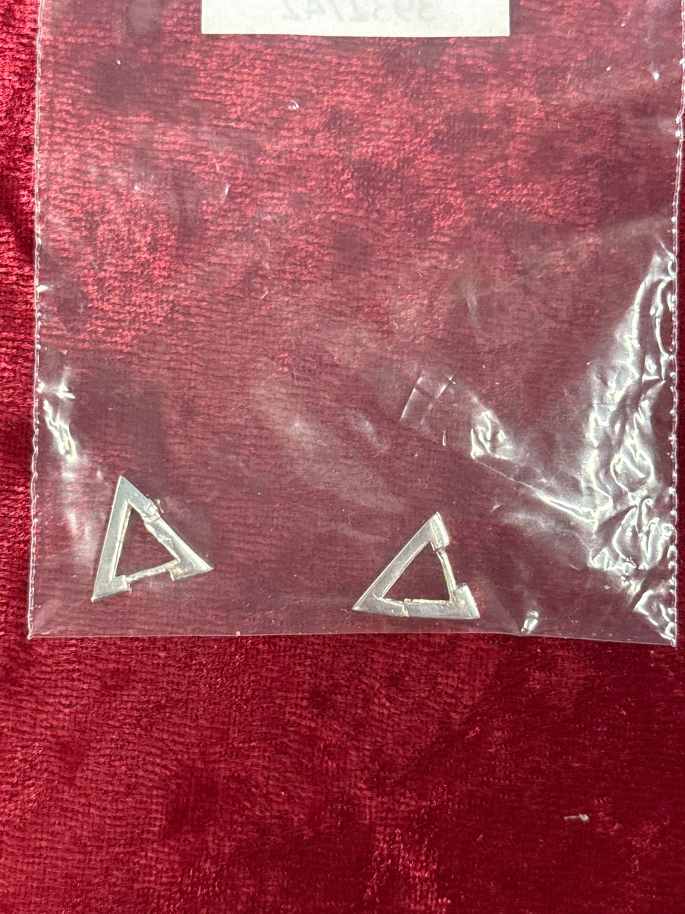 Lot 78: A pair of contemporary silver-toned triangular hoop earrings