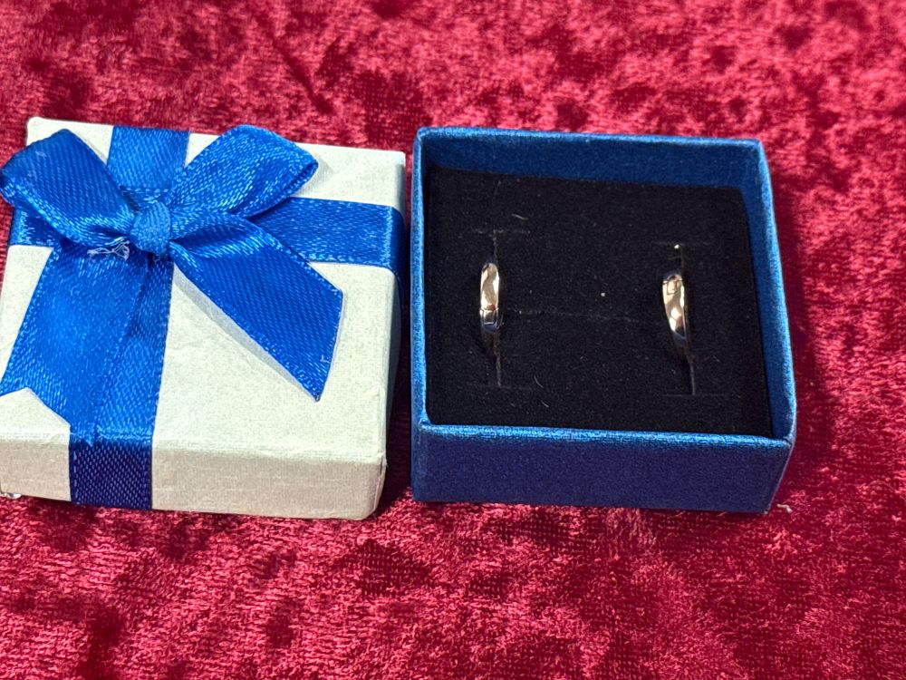 Lot 85: A Pair of Polished Rose Gold Tone Huggie Hoop Earrings